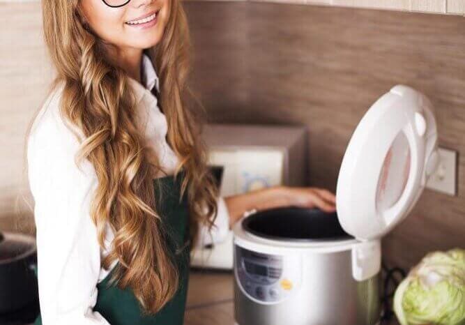 beautiful girl in the kitchen with slo-cooker